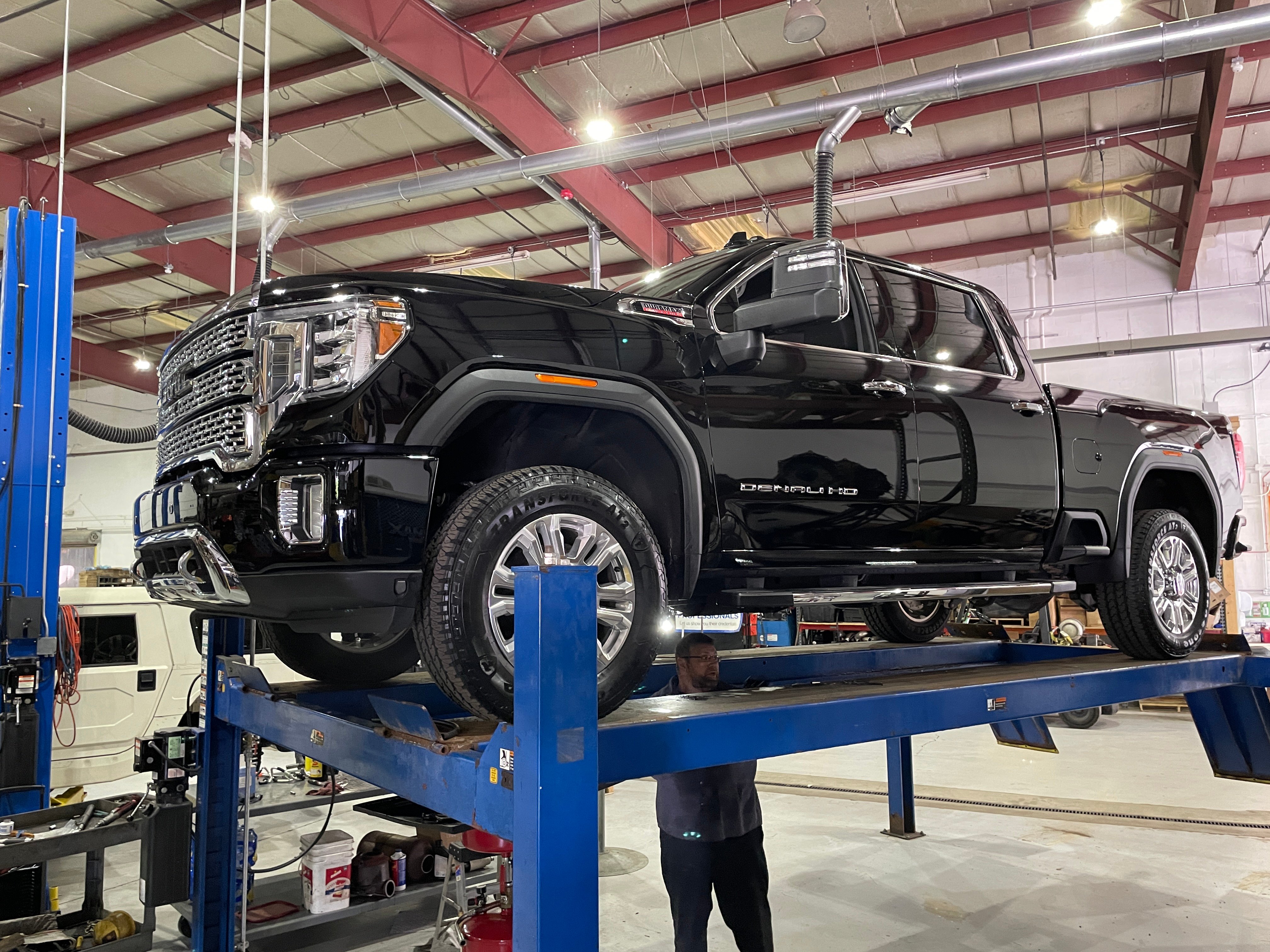 L5P Shift Kit Install 2 Black L5P Truck Duramax In The Shop on Lift GMC Sierra